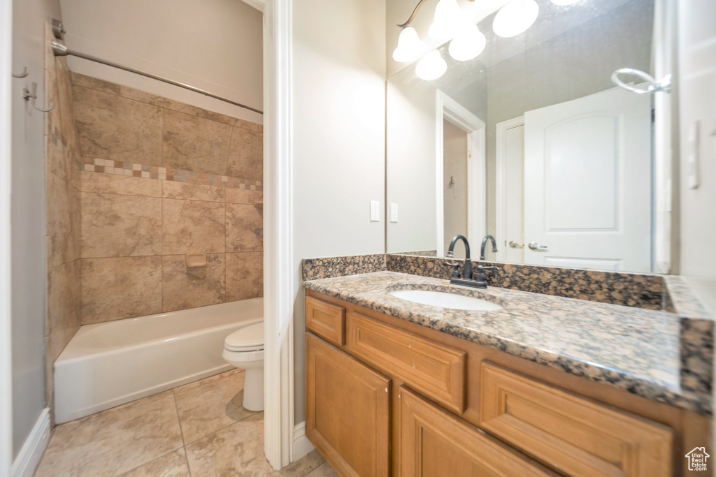 Bathroom featuring toilet, vanity, and bathing tub / shower combination