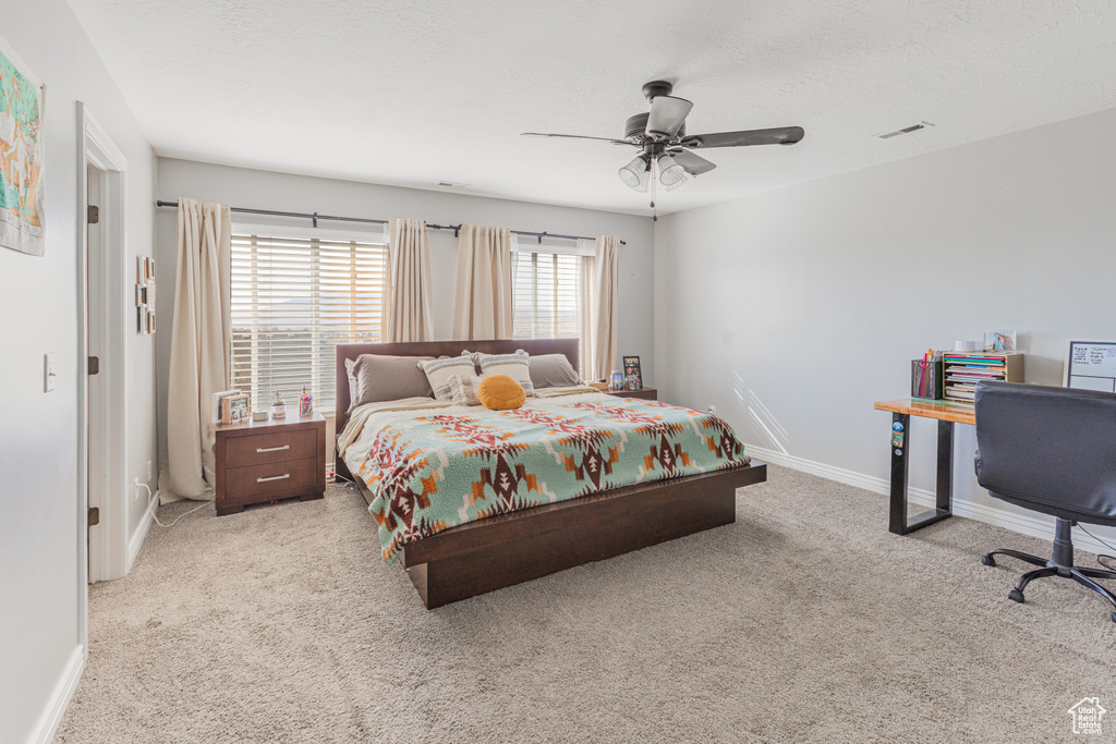Bedroom featuring carpet, baseboards, and ceiling fan