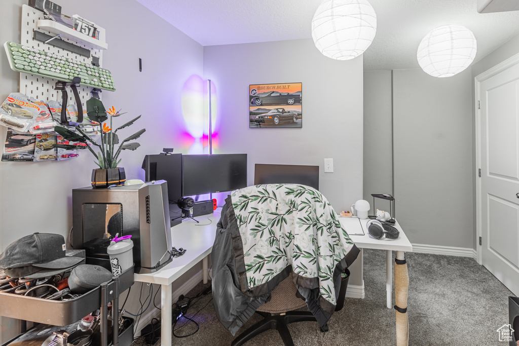 Home office with carpet floors and baseboards