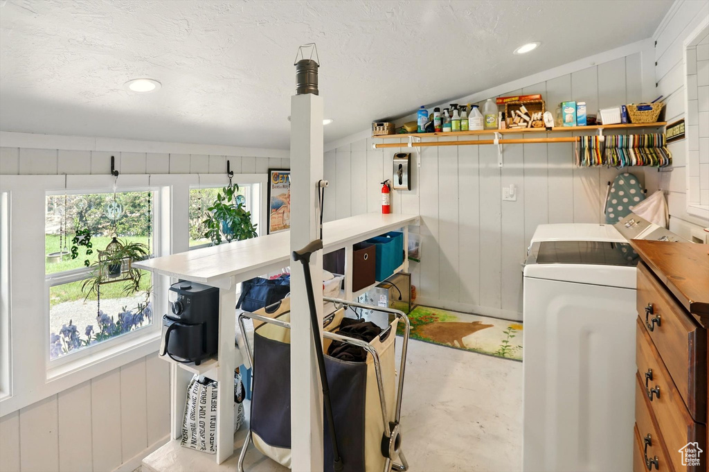 Laundry room with washer / dryer and a decorative wall