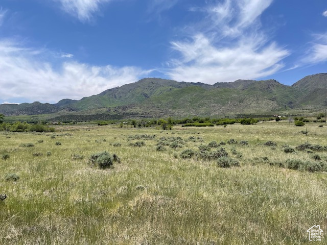 View of mountain backdrop featuring rural landscape