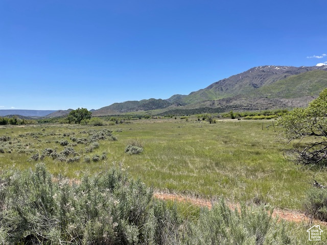 View of mountain backdrop featuring rural landscape