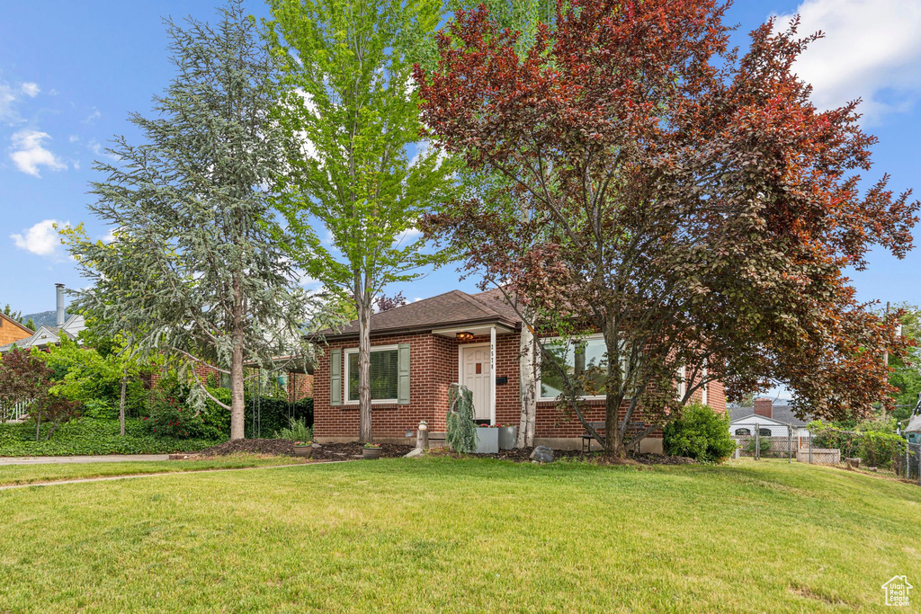 View of front of home with brick siding and a shingled roof