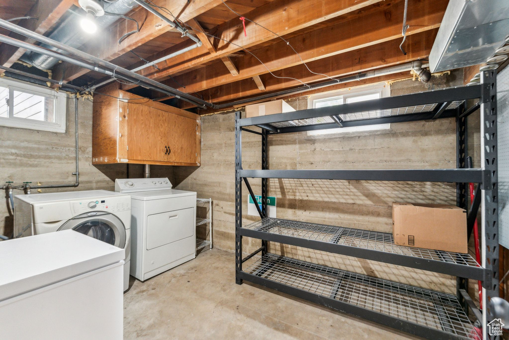Laundry room featuring cabinet space and independent washer and dryer