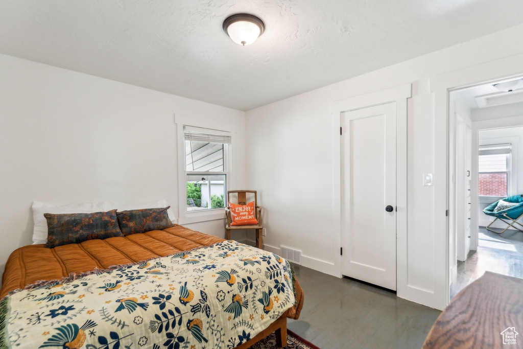 Bedroom with wood finished floors and baseboards