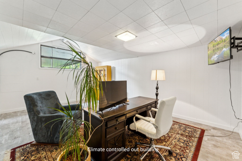 Office area featuring baseboards and lofted ceiling