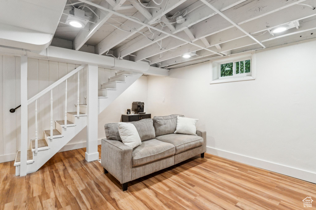 Living area featuring wood finished floors, stairs, and baseboards