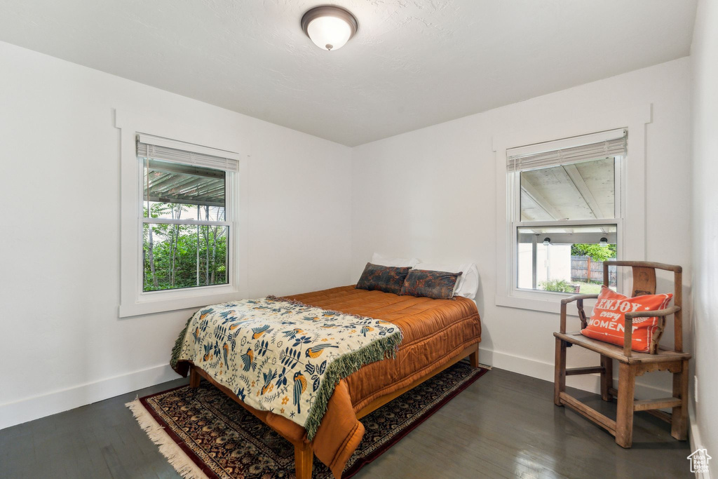 Bedroom with baseboards and wood finished floors