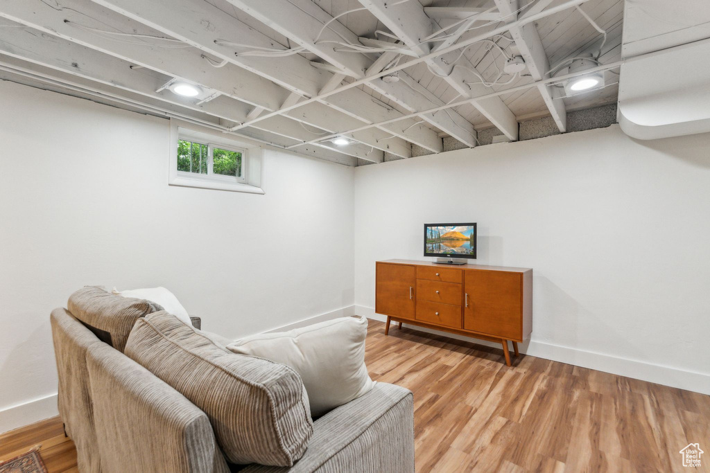 Living area with light wood-style flooring and baseboards