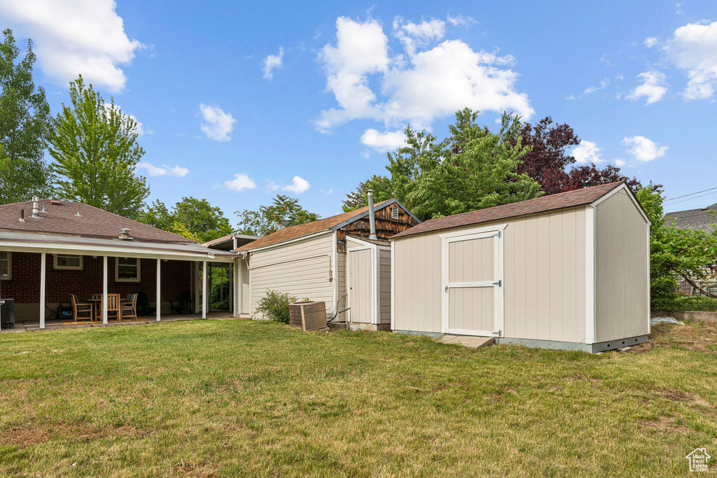 View of grassy yard featuring a patio area and cooling unit