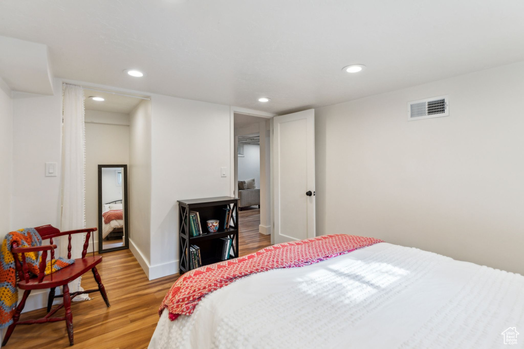 Bedroom featuring light wood finished floors, recessed lighting, and baseboards