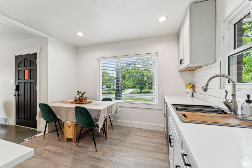 Dining room featuring light wood-style floors, recessed lighting, and baseboards