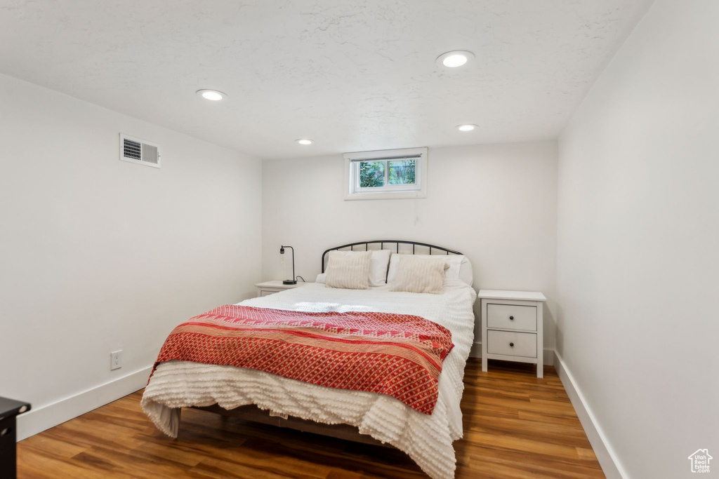 Bedroom featuring wood finished floors, recessed lighting, and baseboards