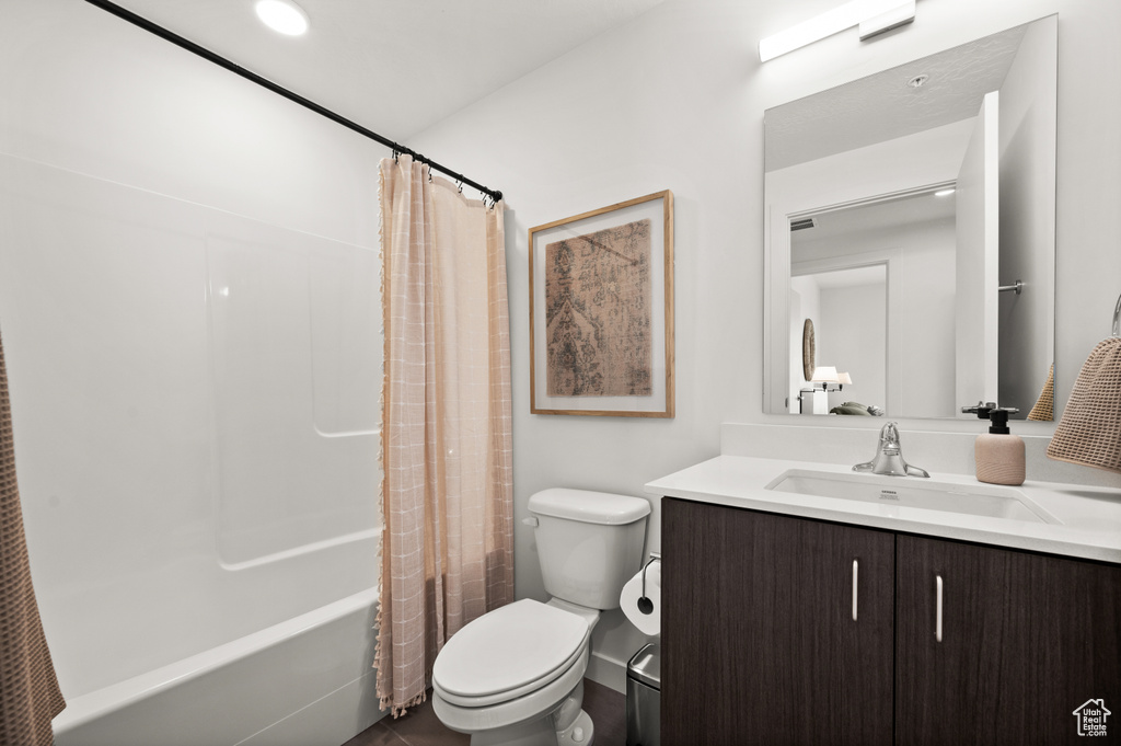 Bathroom with toilet, vanity, and shower / tub combo