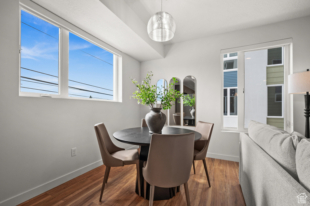 Dining space with baseboards and wood finished floors