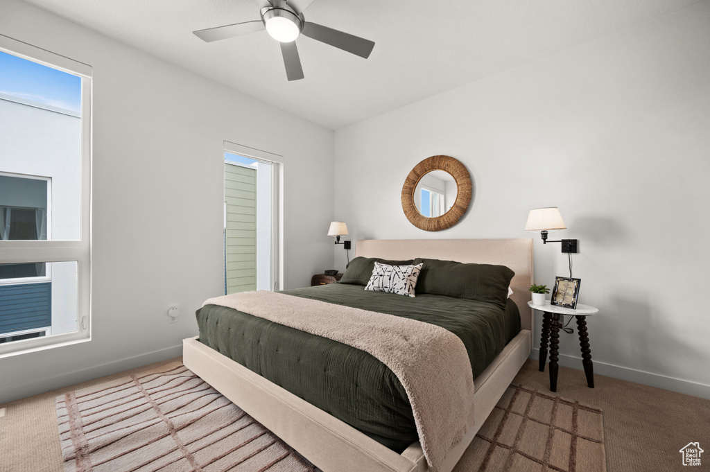 Carpeted bedroom featuring baseboards and a ceiling fan