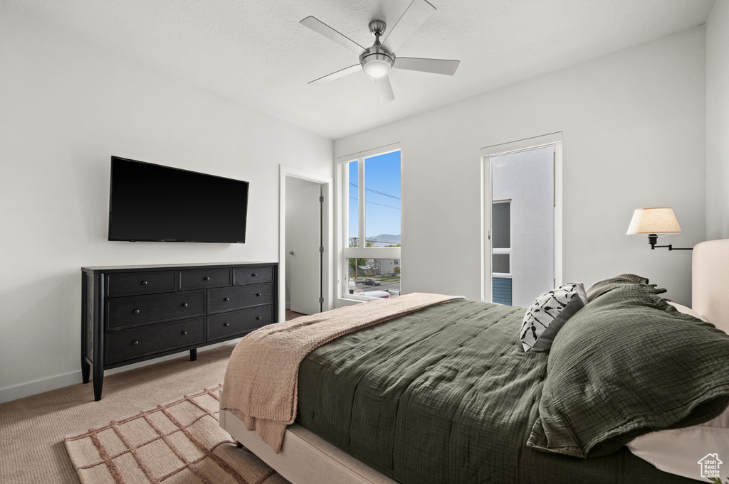 Bedroom with carpet, baseboards, and a ceiling fan