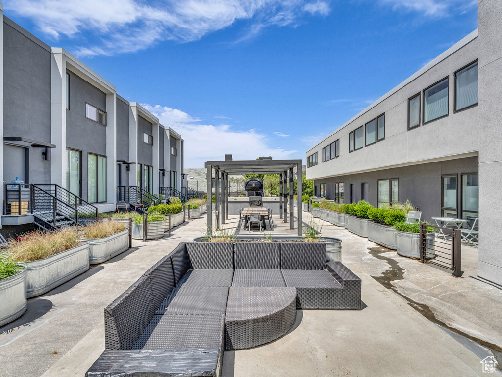 View of community featuring outdoor lounge area, a pergola, and a patio