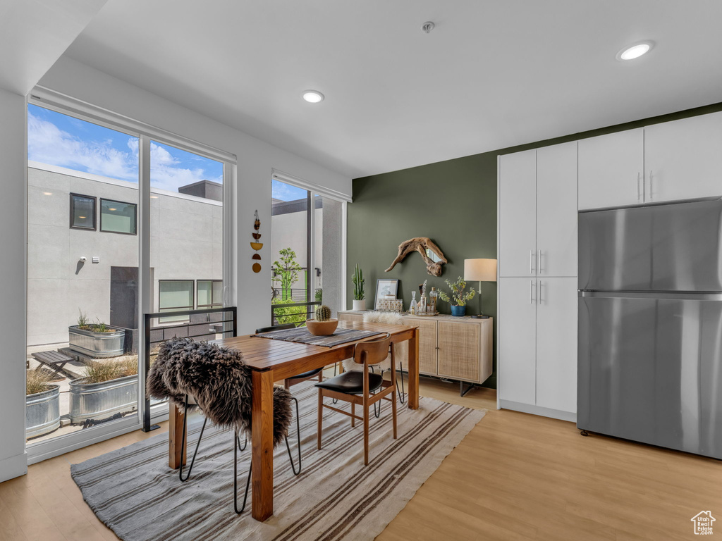 Dining room featuring light wood-type flooring and recessed lighting