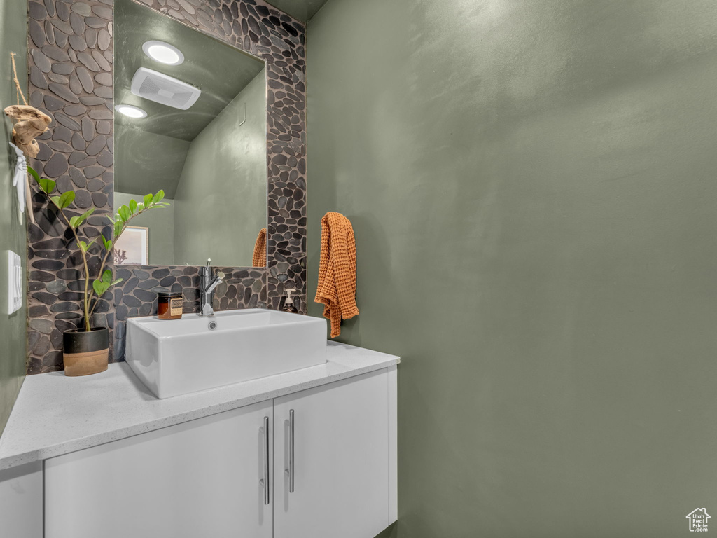 Bathroom with decorative backsplash and vanity