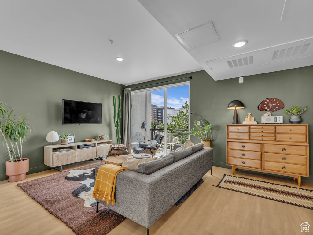 Living room featuring wood finished floors, recessed lighting, and attic access