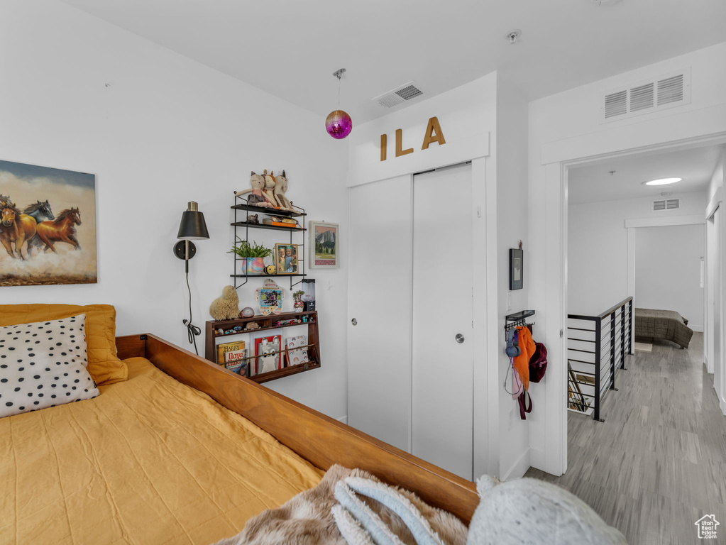 Bedroom featuring a closet, wood finished floors, and baseboards