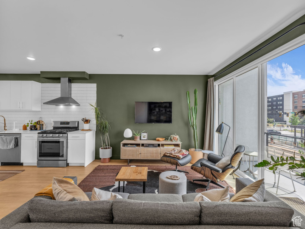 Living room with recessed lighting and light wood-type flooring