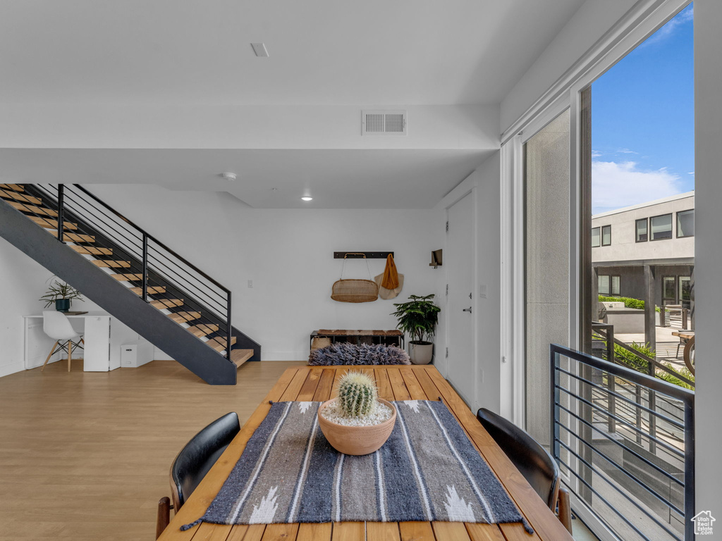 Living room featuring wood finished floors, stairway, and recessed lighting