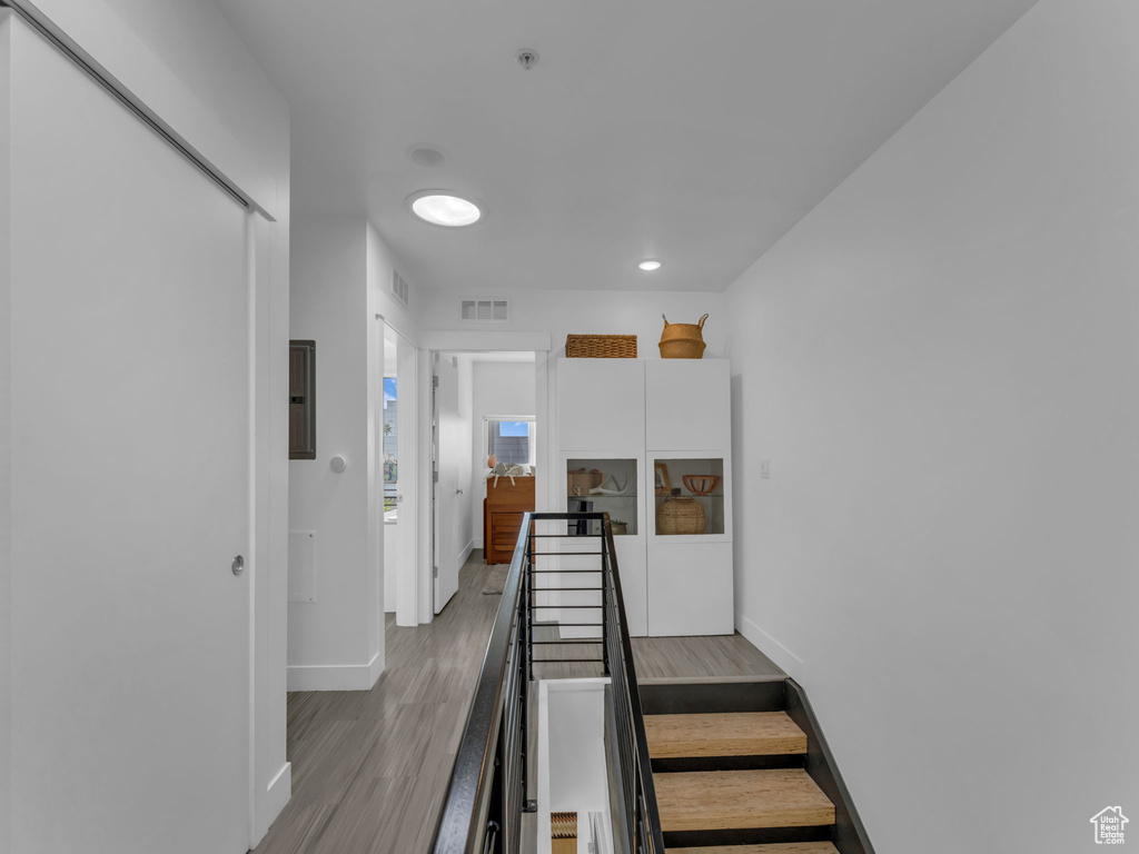 Stairs with baseboards and wood finished floors