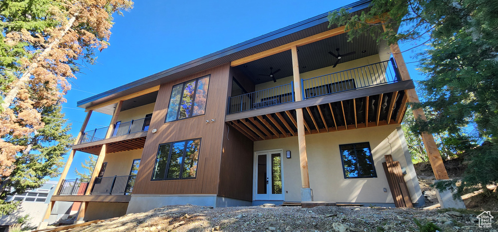 Back of house with a balcony