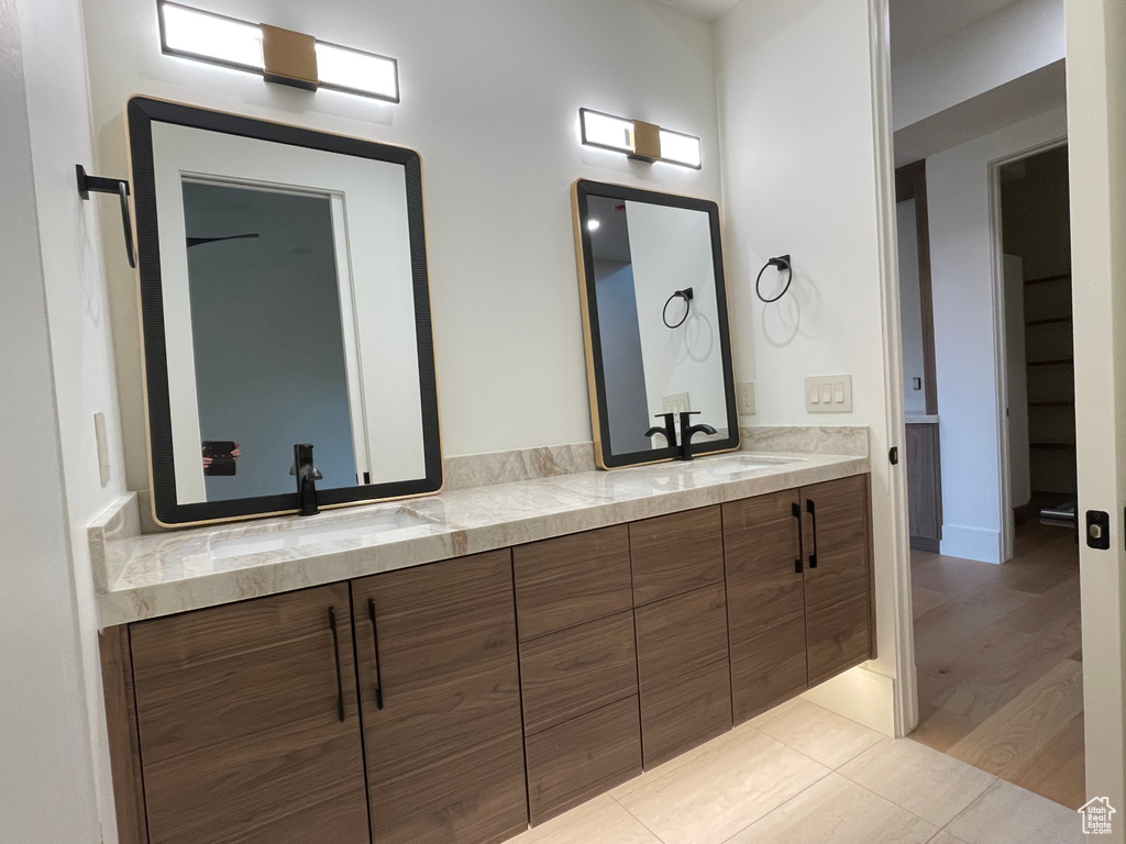Full bathroom featuring double vanity and tile patterned floors