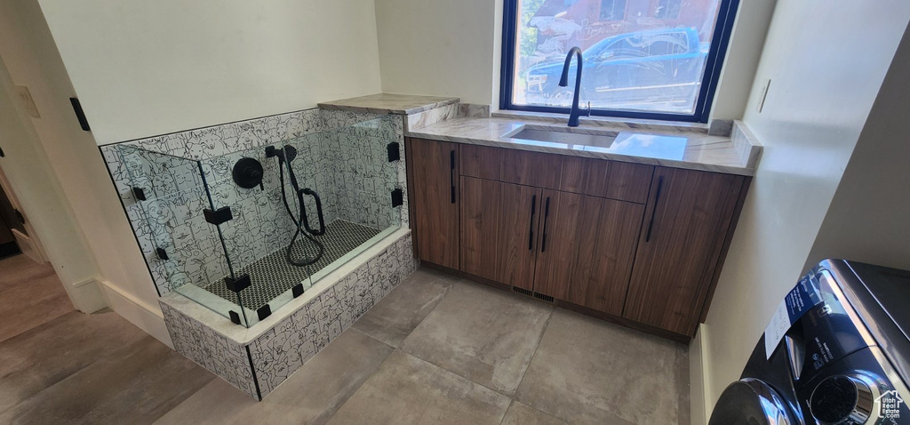 Full bath with a sink and a stall shower