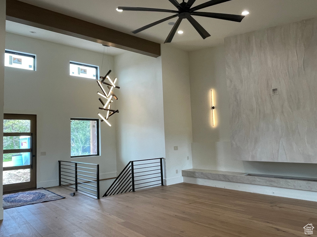 Entrance foyer featuring wood finished floors, recessed lighting, a towering ceiling, beamed ceiling, and a ceiling fan