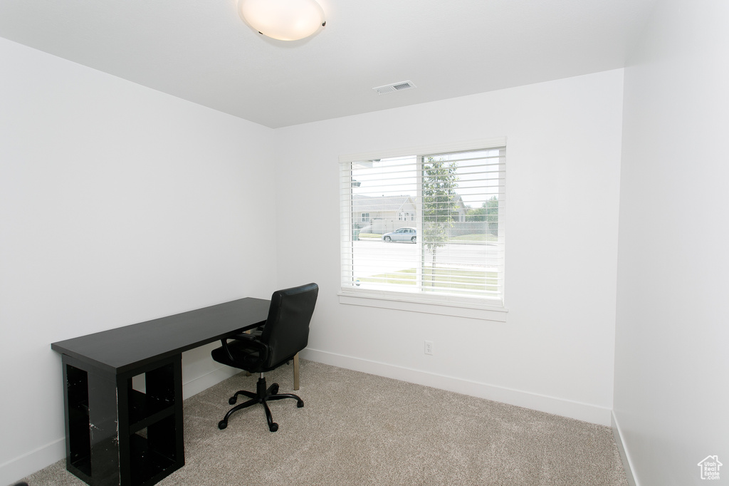 Carpeted office space featuring baseboards