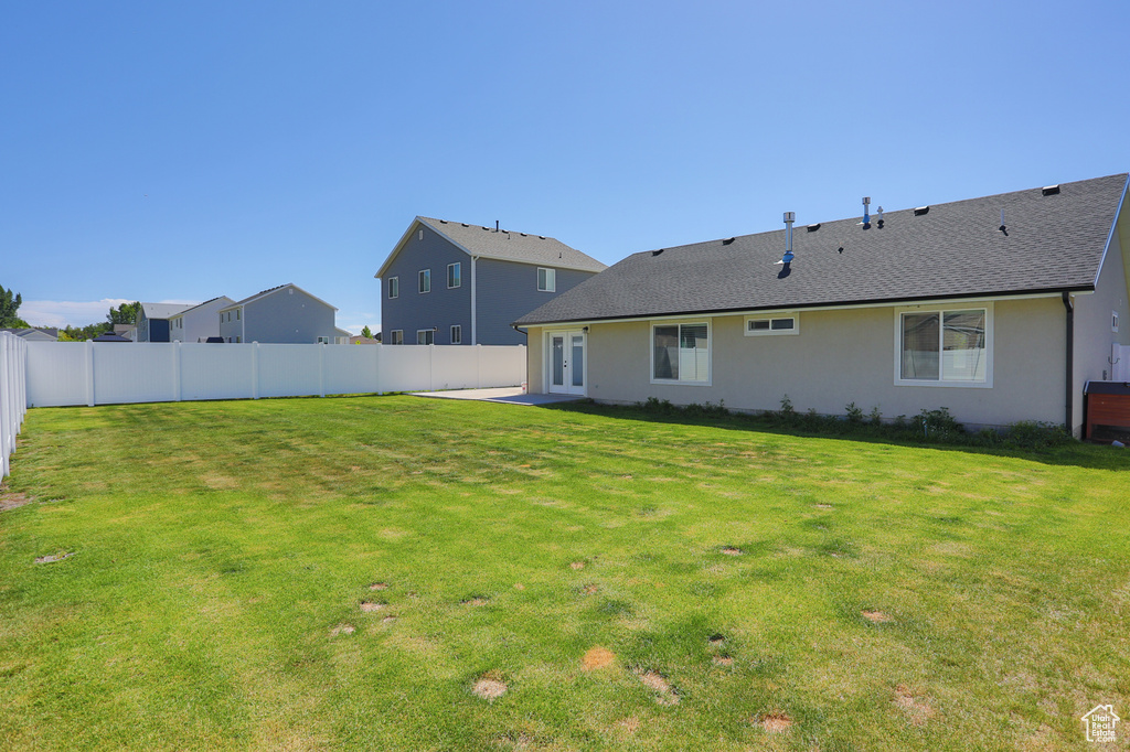 Back of house featuring stucco siding and french doors