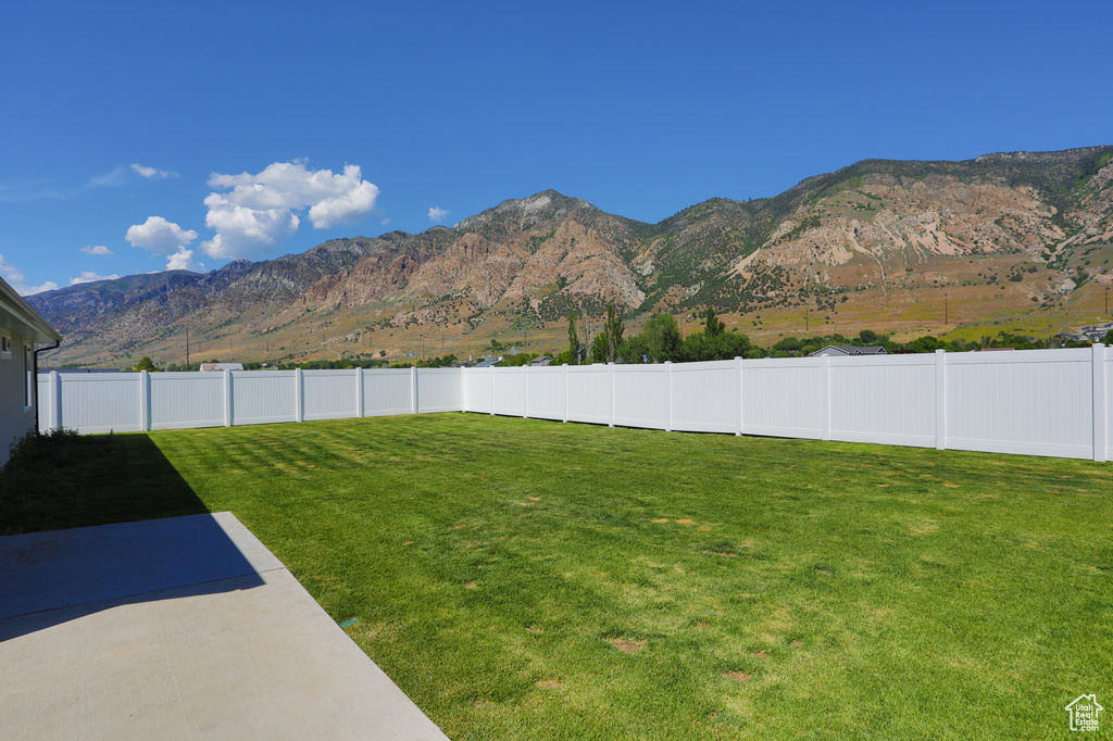 View of yard with a mountain view and a patio