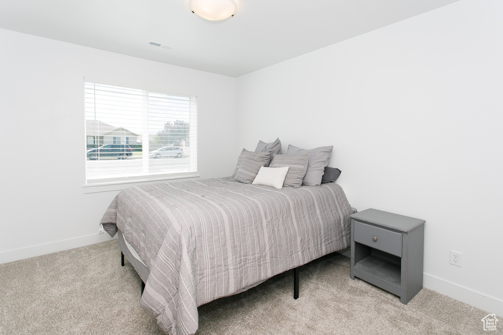 Carpeted bedroom with baseboards