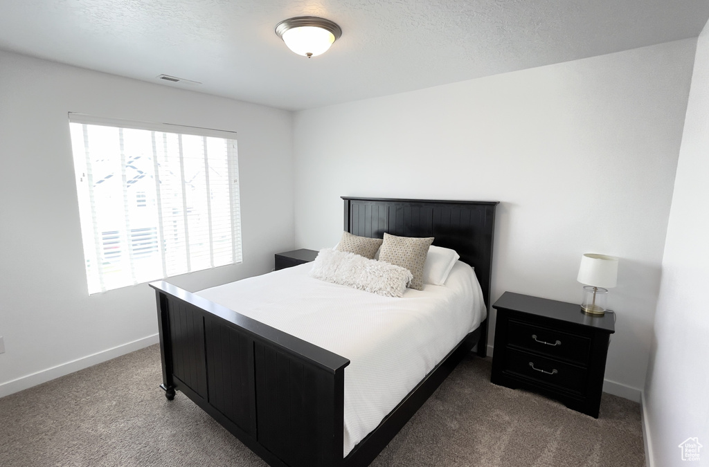 Bedroom with carpet and baseboards