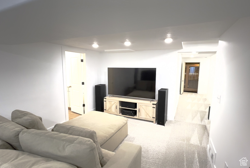 Living area featuring light carpet