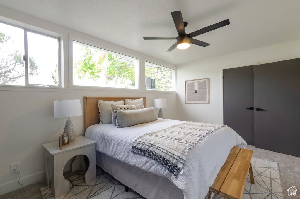 Bedroom featuring light colored carpet and a ceiling fan