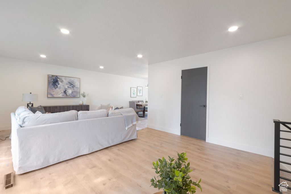 Living area featuring light wood-type flooring, recessed lighting, and baseboards