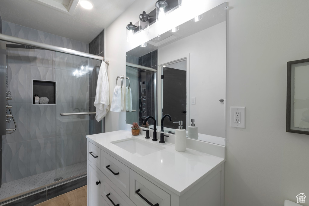 Bathroom featuring vanity and a stall shower