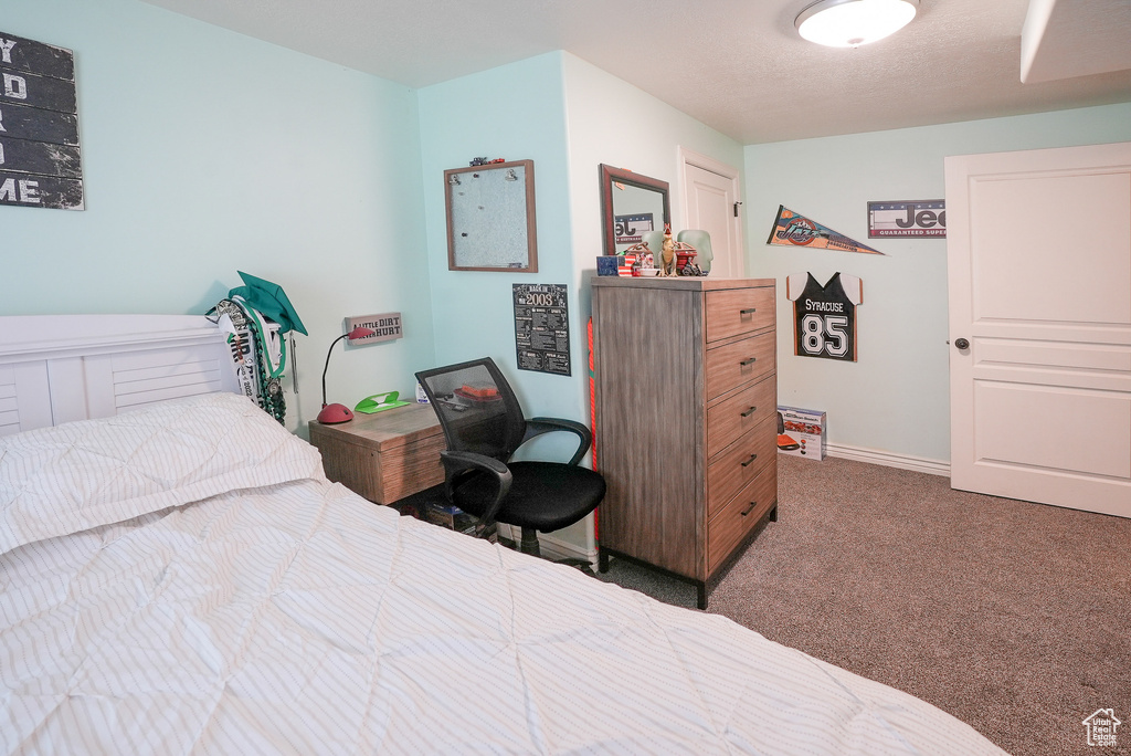 Carpeted bedroom featuring baseboards