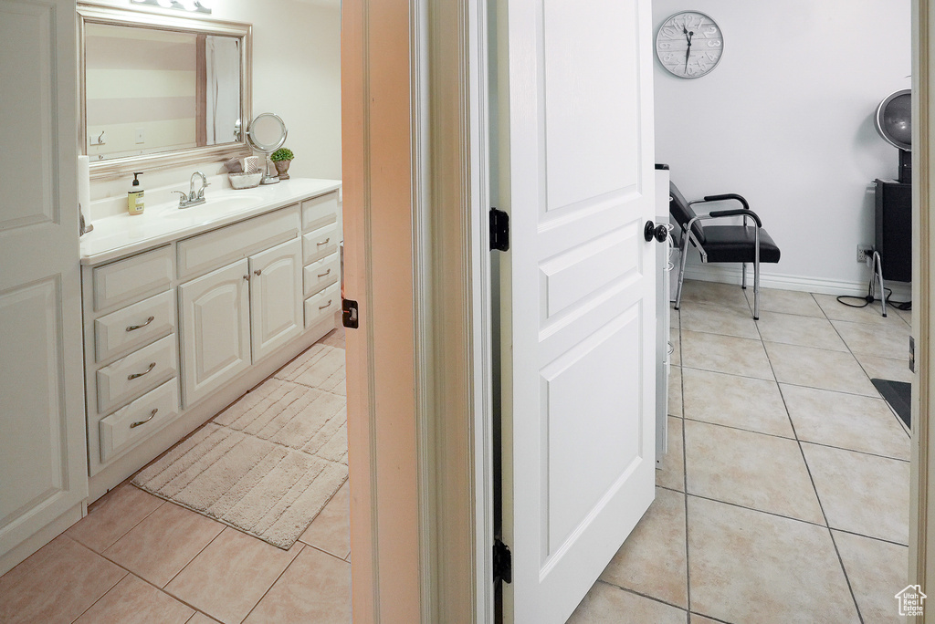 Bathroom featuring tile patterned floors and vanity
