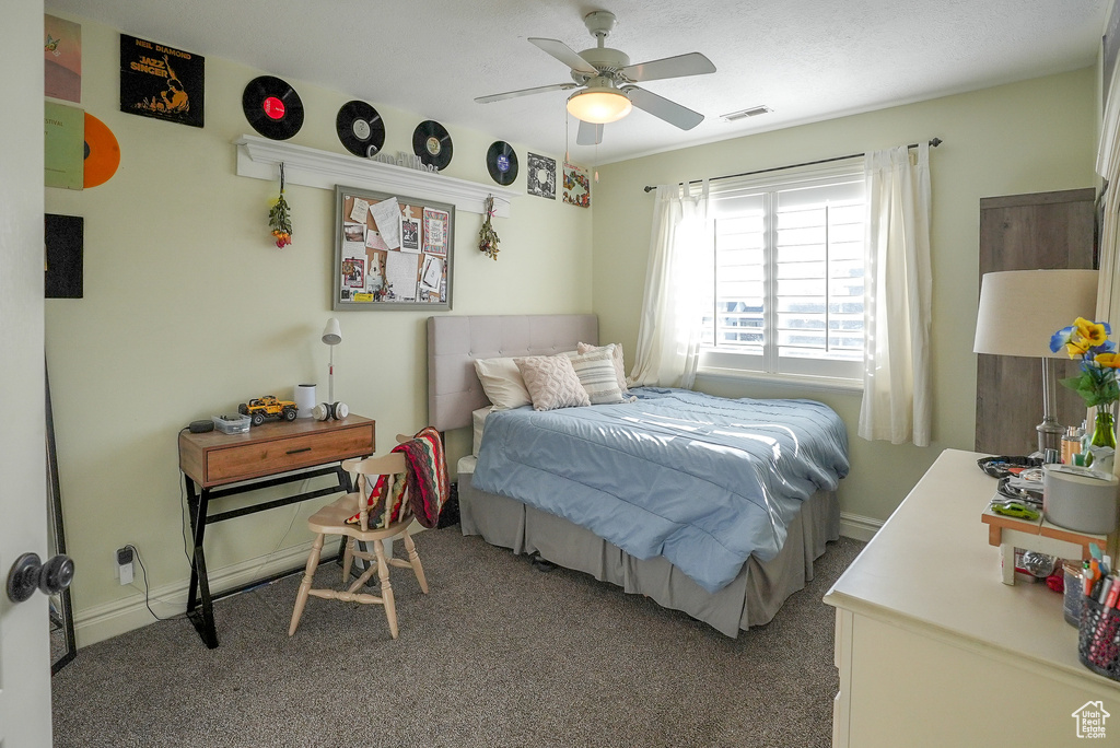 Bedroom featuring carpet, ceiling fan, and baseboards