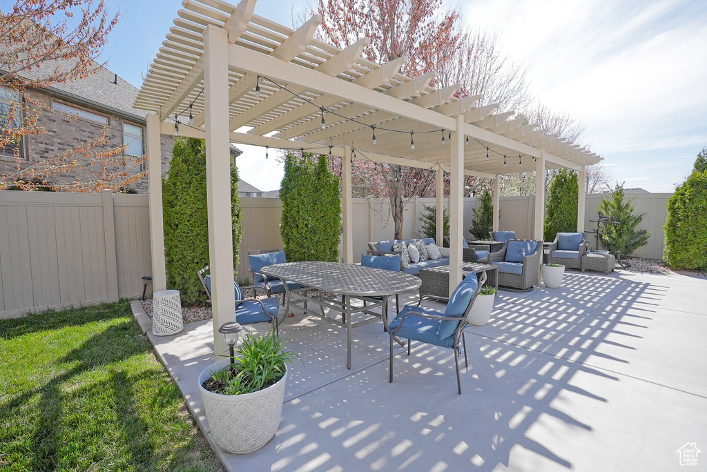 Fenced backyard featuring an outdoor hangout area, a pergola, a patio area, and outdoor dining space