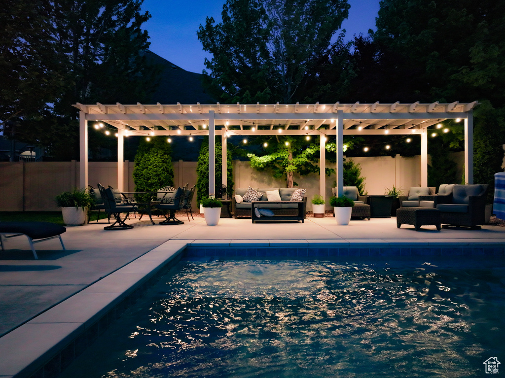 View of swimming pool with an outdoor living space, a pergola, and a patio