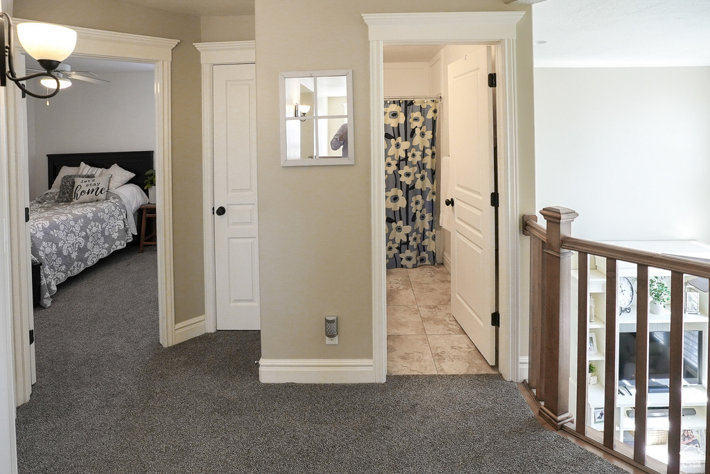 Hallway featuring carpet and baseboards
