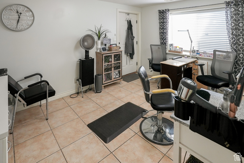 Home office with light tile patterned floors and baseboards