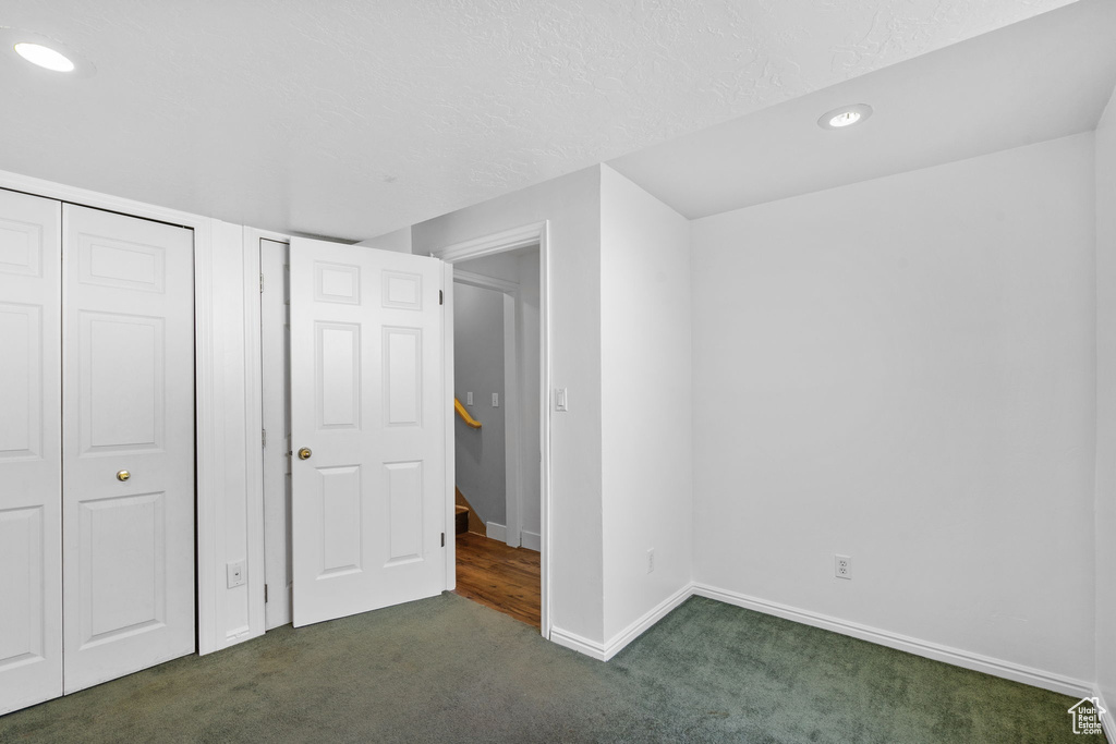 Unfurnished bedroom featuring carpet, recessed lighting, baseboards, and a textured ceiling